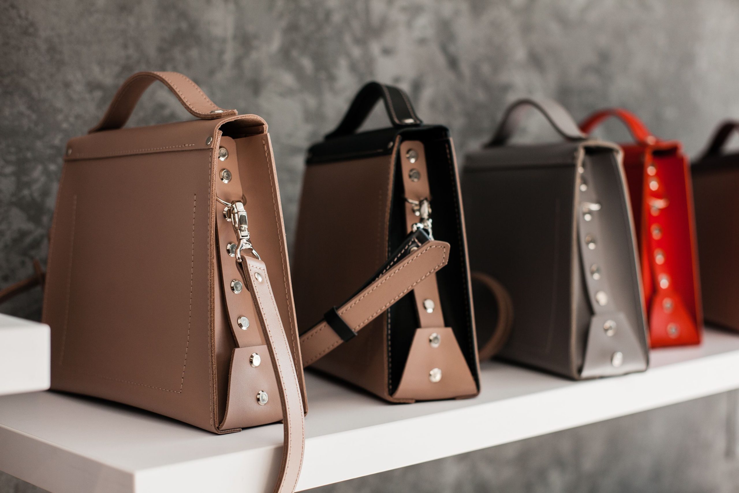 Sacs cuir luxe minimalistes sur étagère blanche